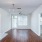 Living room with front door entry and a large window at Pavilion at Lake Apartments