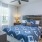 Bedroom with large windows and ceiling fan at Pavilion at Lake Apartments